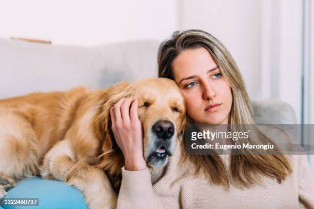 italy, young woman with dog at home - worried pet owner stock pictures, royalty-free photos & images