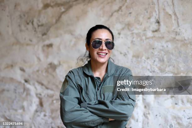 mid aged adult female who is in the air forced dresses in aviator outfit. - piloten sonnenbrille stock-fotos und bilder