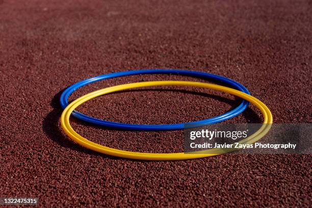 two yellow and blue rhythmic gymnastics hoops - world rhythmic gymnastics championship 2021 stock pictures, royalty-free photos & images