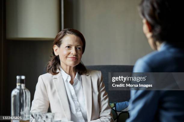 businesswomen planning strategy in meeting - businesswoman hotel stock pictures, royalty-free photos & images