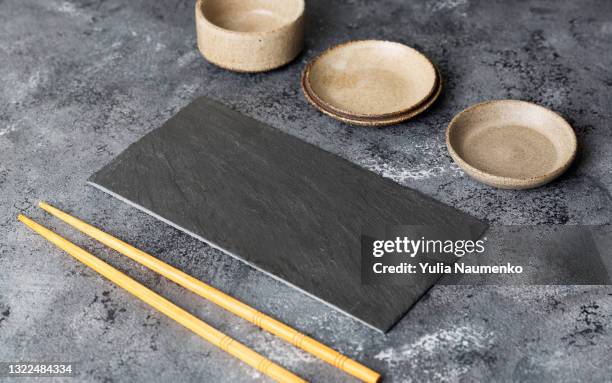 stone plate and chopsticks for your sushi - 皿　和 ストックフォトと画像