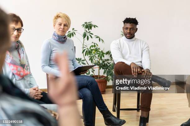 a group chatting in a mental health meeting - aa meeting stock pictures, royalty-free photos & images