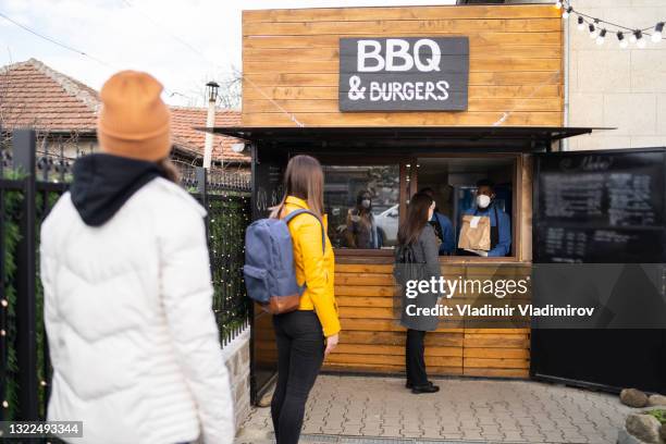 waiting in line outside for a takeaway food - restaurants open during lockdown stock pictures, royalty-free photos & images