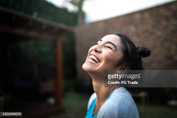 happy woman inhaling at home - lachen stockfoto's en -beelden