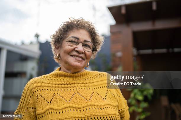 portrait of a senior woman at home - senior woman short hair stock pictures, royalty-free photos & images