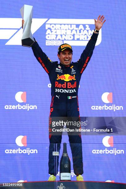 Sergio Perez of Mexico and Red Bull Racing celebrates on the podium after winning the F1 Grand Prix of Azerbaijan at Baku City Circuit on June 06,...