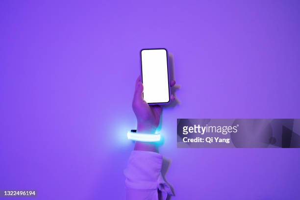 woman wearing glowing smart watch using mobile phone - ai human hand stock pictures, royalty-free photos & images