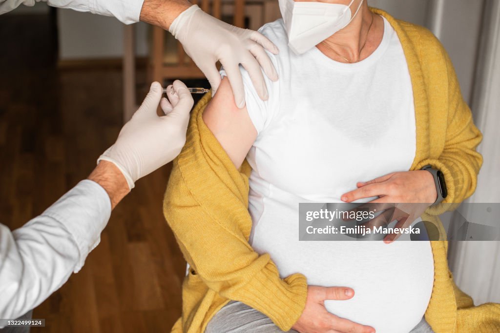 Pregnant woman taking a vaccination