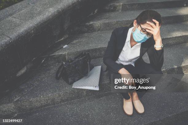 unemployed businesswoman having stressed after failure and laid off from work because impact from covid-19 pandemic outbreak and economic depression. - defeat covid stock pictures, royalty-free photos & images