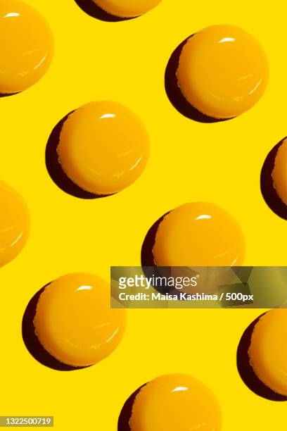 full frame shot of yellow candies against yellow background,rio de janeiro,brazil - egg yolk stock pictures, royalty-free photos & images