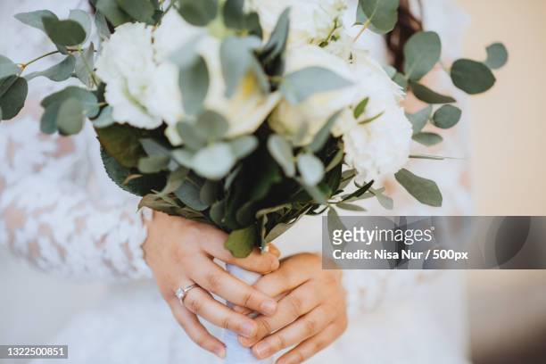 midsection of bride holding bouquet,germany - bride holding bouquet stock pictures, royalty-free photos & images