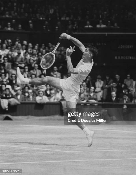 Ken Rosewall of Australia reaches to make an overhead smash return against Jaroslav Drobny of Egypt during their Men's Singles Final match on Centre...