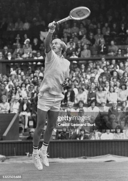 Stan Smith of the United States jumps to make an overhead backhand return against compatriot Jeff Borowiak during their Men's Singles Third Round...