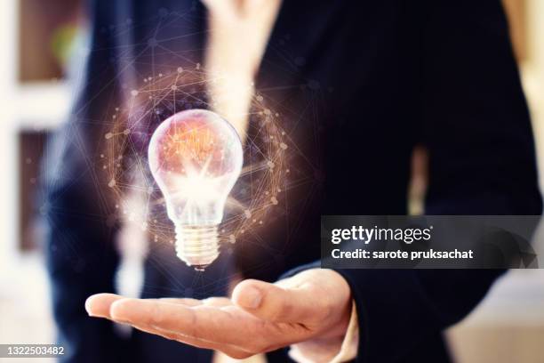 business women holding light bulbs, ideas of new ideas with innovative technology and creativity. - invention of photography is presented to the world stock pictures, royalty-free photos & images