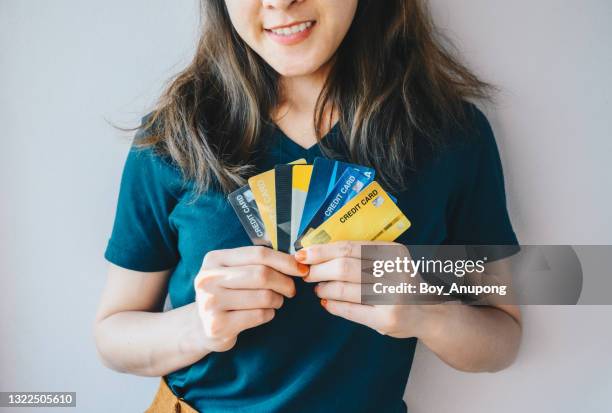 smily woman holding group of credit cards in her hands. - debt collector stockfoto's en -beelden