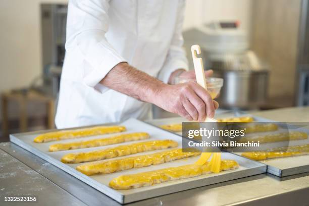 bakery chef hands glazing cantuccini - biscotti stock pictures, royalty-free photos & images