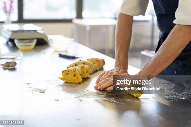 baker hands roll cantuccini dough - almond cookies stock pictures, royalty-free photos & images