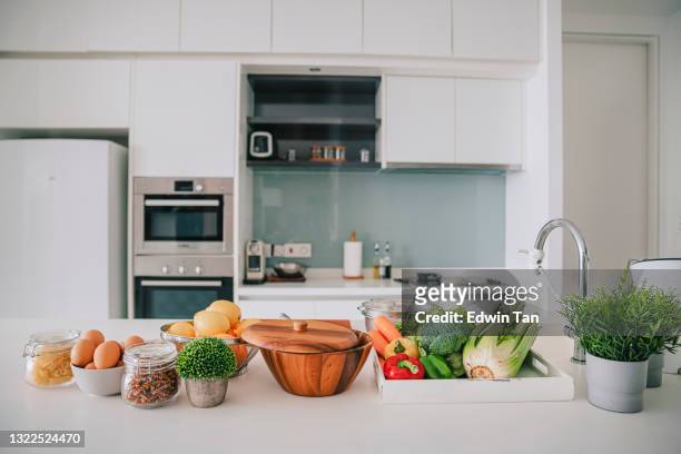 domestic kitchen with fruits and vegetables on kitchen counter - food staple stock pictures, royalty-free photos & images