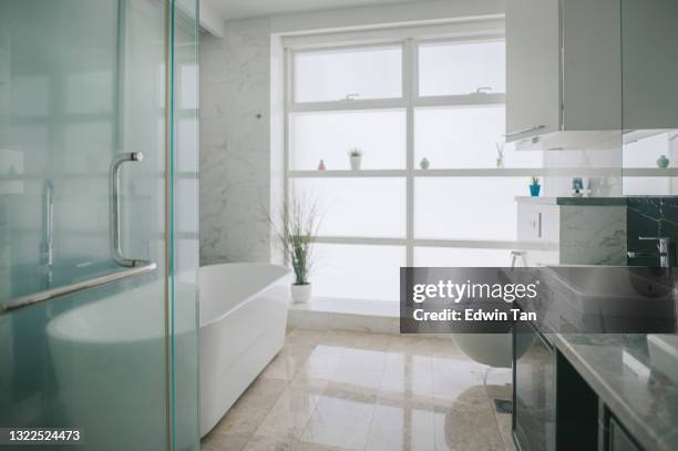 bathroom with bathtub and bright window - new bathtub stock pictures, royalty-free photos & images