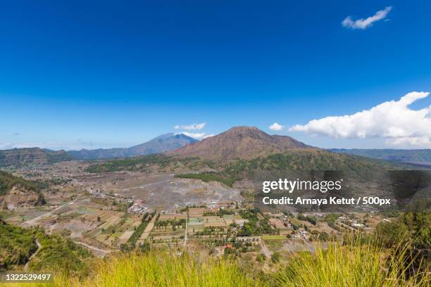 scenic view of landscape against blue sky,kintamani,indonesia - kintamani stock pictures, royalty-free photos & images