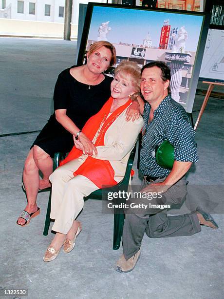Actress Debbie Reynolds, center, poses with her children Carrie Fisher, left, and Todd Fisher June 19, 2001 in Hollywood at the unveiling of the new...