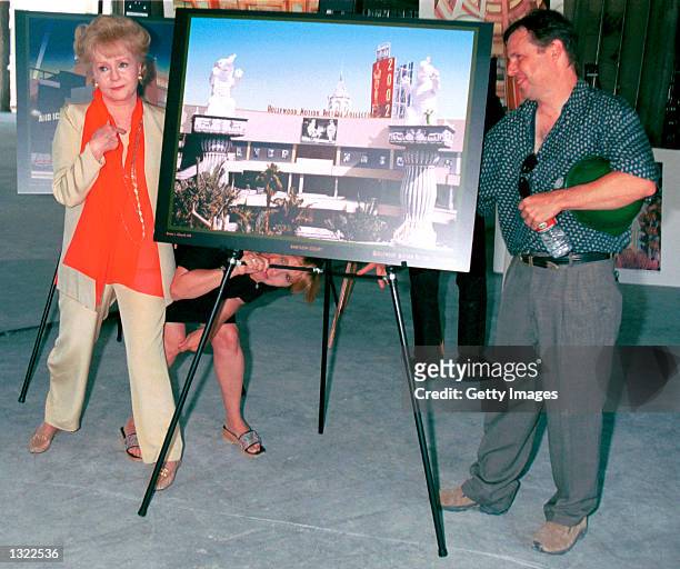 Actress Debbie Reynolds, left, poses with her children Carrie Fisher, center, and Todd Fisher June 19, 2001 in Hollywood at the unveiling of the site...