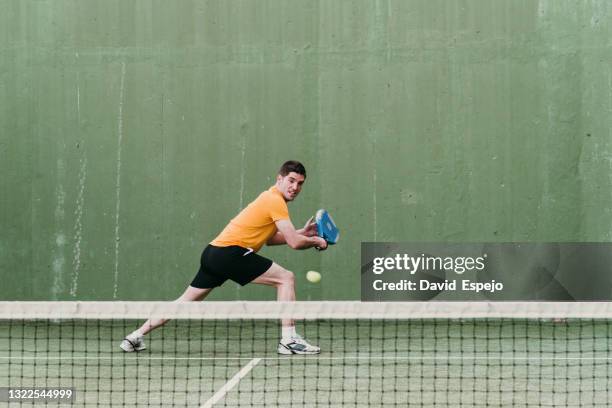 paddle tennis player in the match - schlägersport stock-fotos und bilder