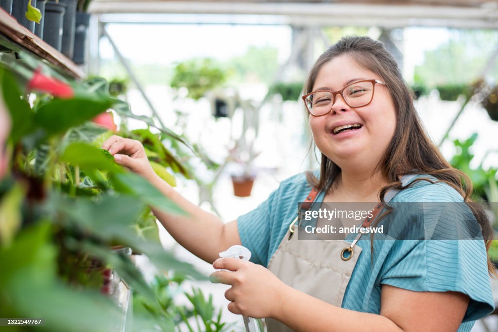 Social inclusion - woman with down syndrome working in small business