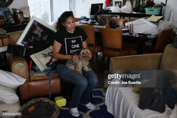 Maria Ray, who has lived at the Hamilton on the Bay apartment building for twelve years, sits with her dog, Daisy, in her apartment after attending a...