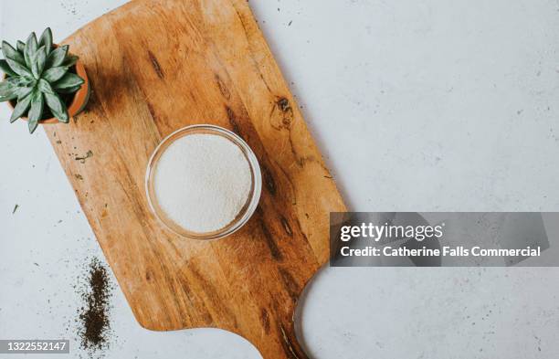 finely ground sugar on a wooden chopping board - sugar spoon stock pictures, royalty-free photos & images