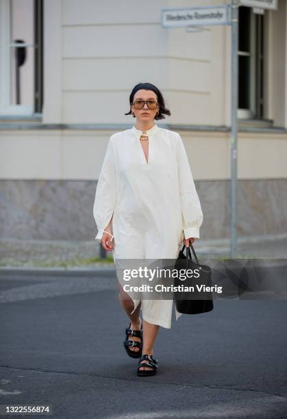 Sophie van Daniels is seen wearing white dress Baum & Pferdgarten, black sandals Arket, Little Liffner bag, vintage sunglasses on June 07, 2021 in...