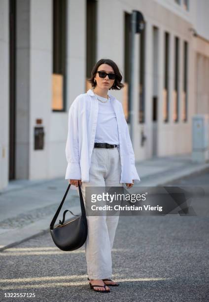 Sophie van Daniels is seen wearing white &otherstories blouse, Arket Tshirt, Arket linen pants, Arket shoes, RETROSUPERFUTURE sunglasses, AGNEEL bag,...