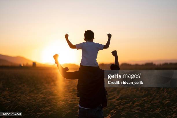 dad and son outdoors - muscular build stock pictures, royalty-free photos & images