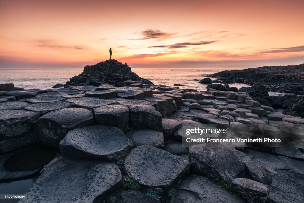 Tourist at The Giant's Causeway, Northern Ireland, UK.