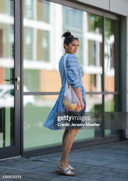 Anna Wolfers wearing blue and white summer dress via Goldig Shop and white Chloé slides on May 31, 2021 in Hamburg, Germany.