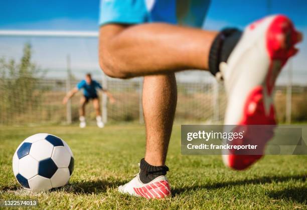 legs of soccer player kicking the ball - football boot stock pictures, royalty-free photos & images