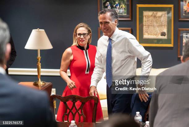 Sens. Kyrsten Sinema and Mitt Romney arrive for a bipartisan meeting on infrastructure after original talks fell through with the White House on June...