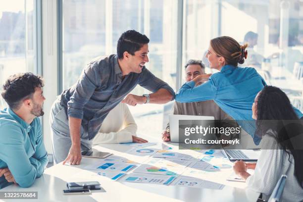 business people doing a covid handshake elbow bump during a business meeting. - touching elbows stock pictures, royalty-free photos & images