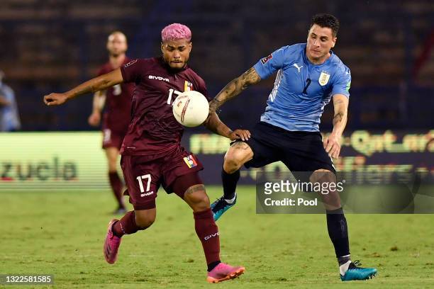 Josef Martínez of Venezuela fights for the ball with José Giménez of Uruguay during a match between Venezuela and Uruguay as part of South American...
