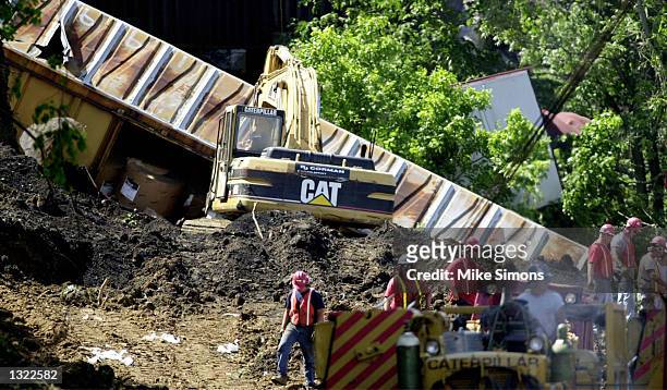 Workers clean up a CSX train derailment June 18, 2001 in Wilmington, OH, 60 miles southwest of Columbus. The train derailed on June 17, spilling...