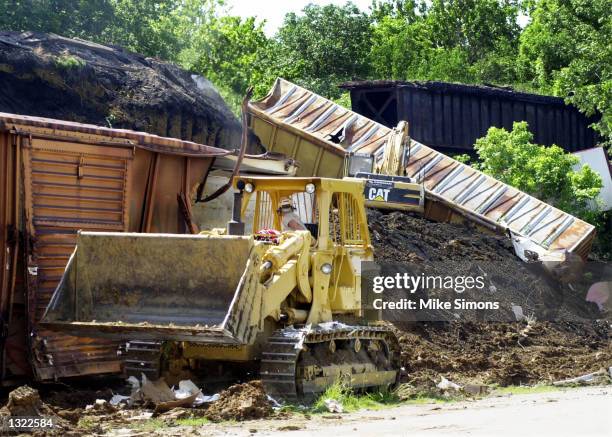 Workers clean up a CSX train derailment June 18, 2001 in Wilmington, OH, 60 miles southwest of Columbus. The train derailed on June 17, spilling...