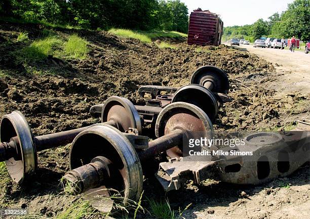 Train parts lie on the side of the State Route 68 June 18, 2001 as workers clean up a CSX train derailment in Wilmington, OH, 60 miles southwest of...