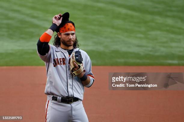 Brandon Crawford of the San Francisco Giants acknowledges his teammates and fans while being recognized for setting a franchise record playing 1,326...