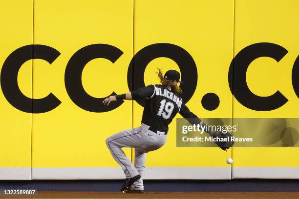 Charlie Blackmon of the Colorado Rockies can't catch a 2-run triple hit by Corey Dickerson of the Miami Marlins during the third inning at loanDepot...