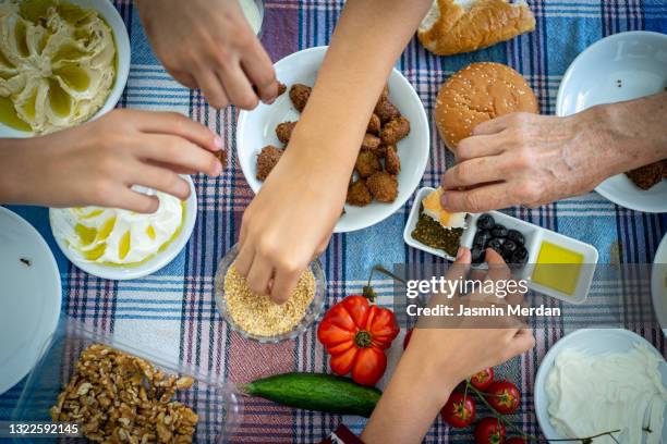 middle eastern breakfast with hands over meal - middle east oil stock pictures, royalty-free photos & images