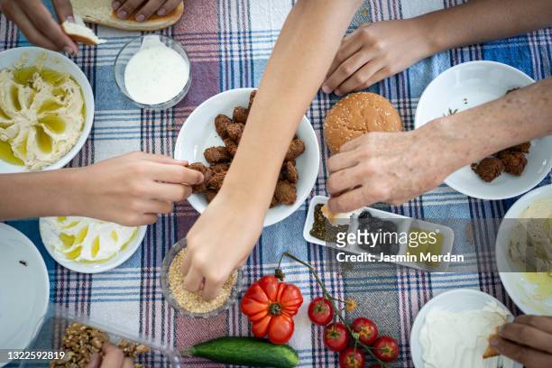 middle eastern breakfast with hands over meal - middle east oil stock pictures, royalty-free photos & images
