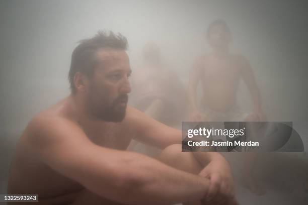 mature man in steam room sauna - badhuis stockfoto's en -beelden