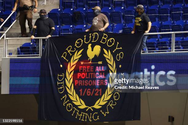 Fans display a banner reading "Proud Boys Did Nothing Wrong" during the seventh inning of the game between the Miami Marlins and the Colorado Rockies...