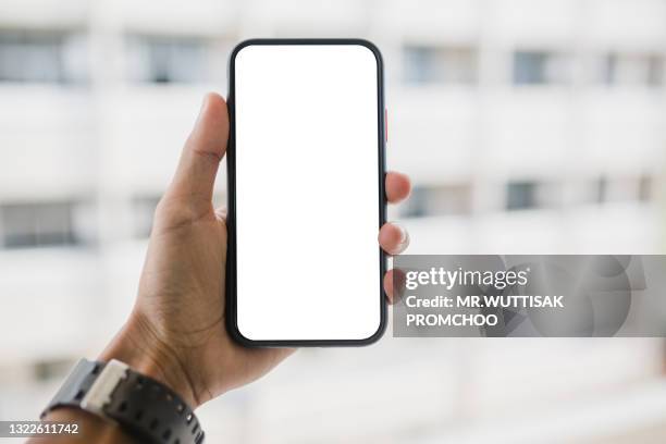 white space smartphone. - man holding phone stock-fotos und bilder