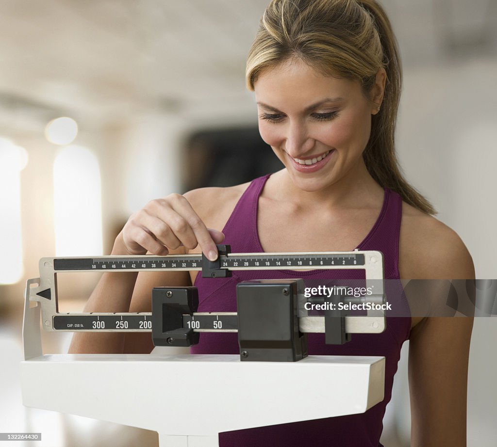 Woman weighing herself